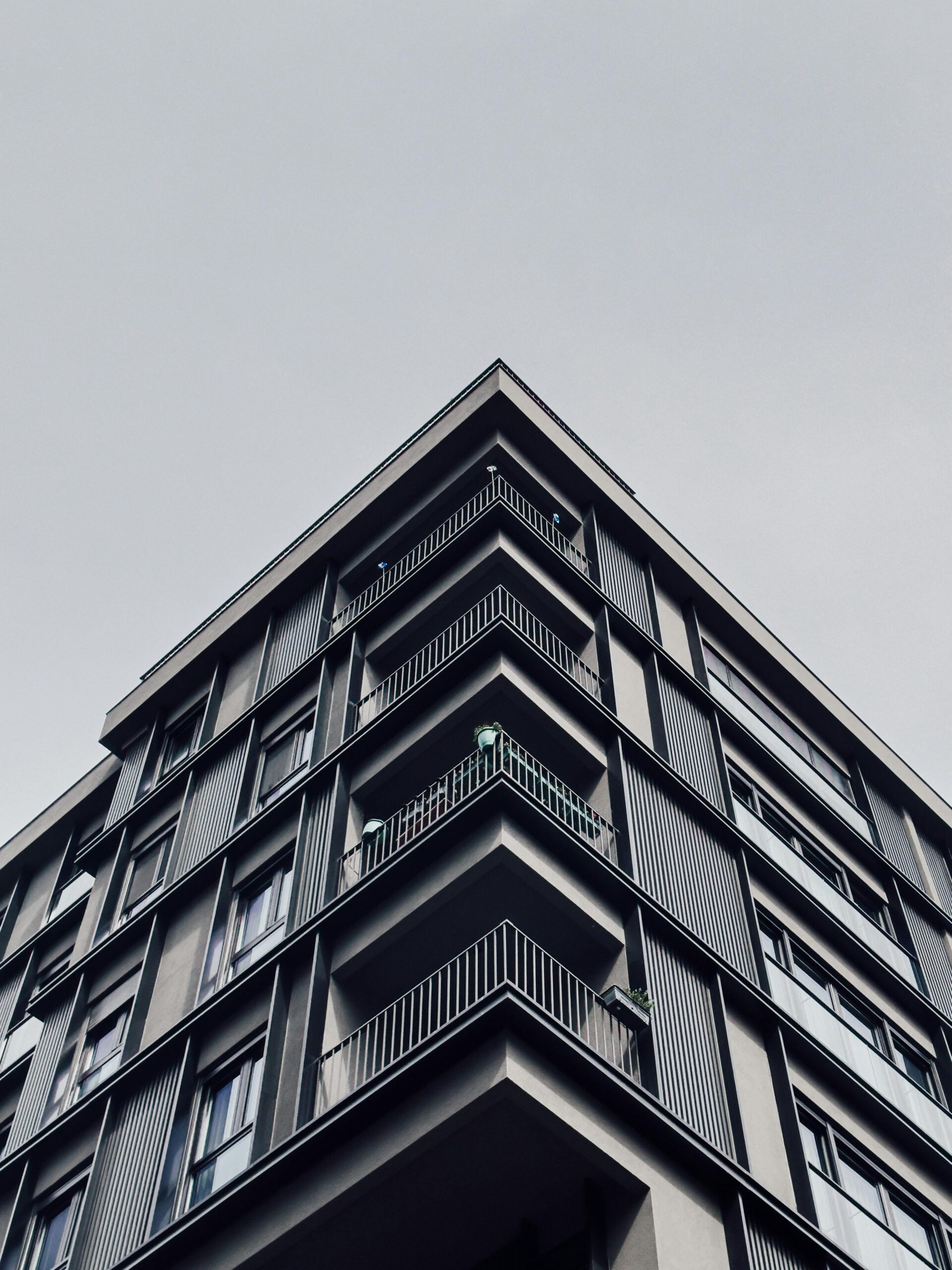 Low angle view of a sleek modern apartment building's facade.