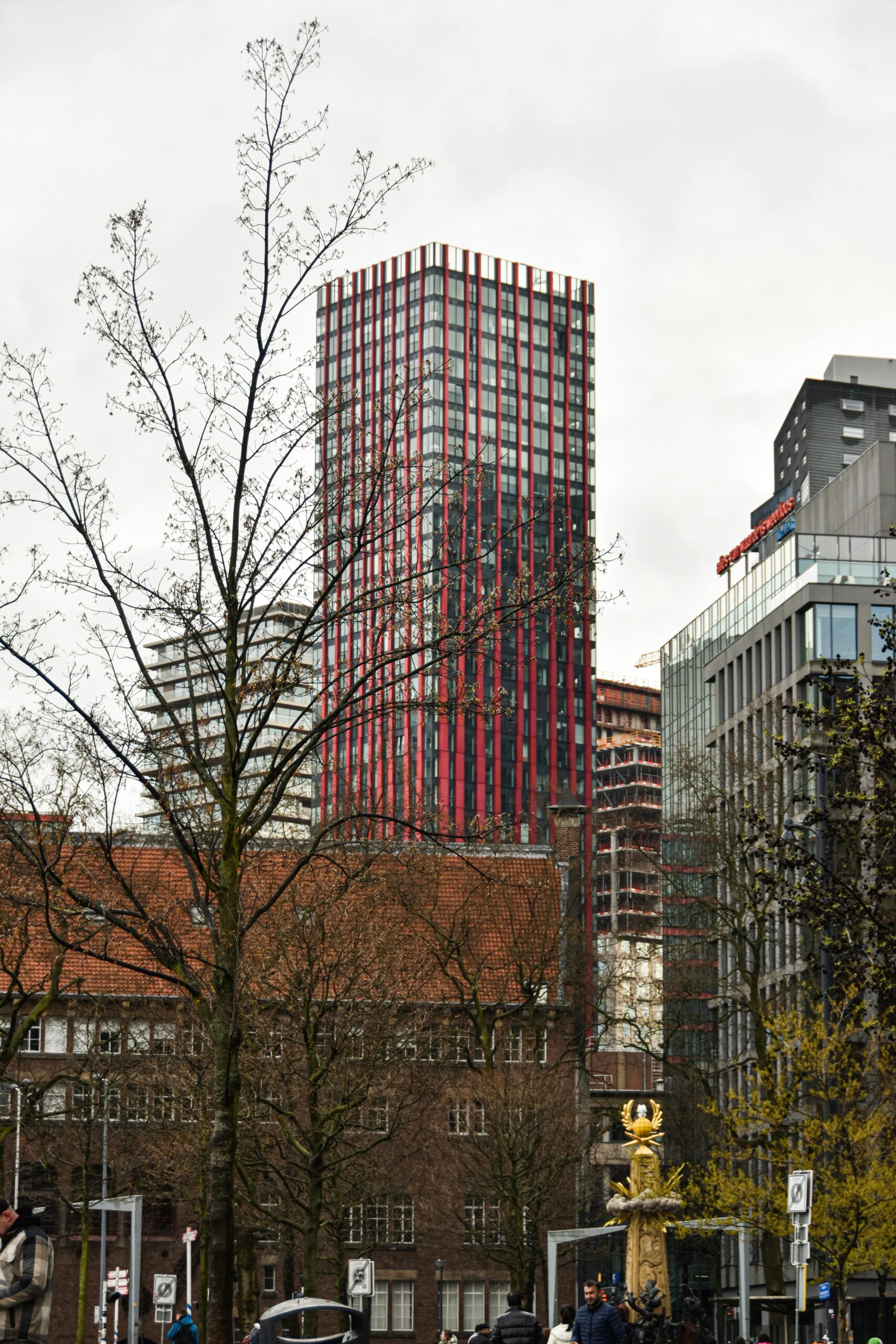 Captivating view of modern city skyline featuring distinctive red skyscraper.